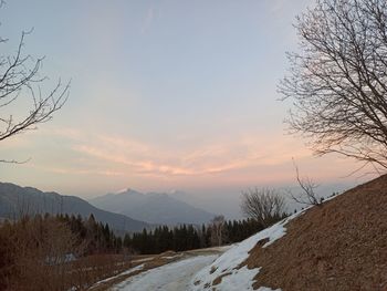 Scenic view of snowcapped mountains against sky during sunset