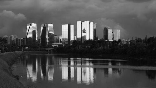 Reflection of buildings in lake against sky