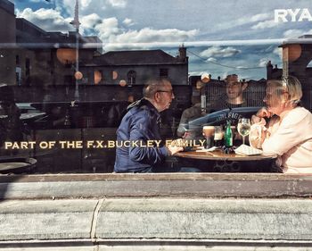 People sitting in front of buildings