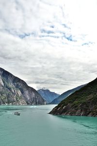 Scenic view of sea and mountains against sky