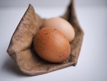 Close-up of eggs against white background