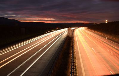 Light trails on road in city at night