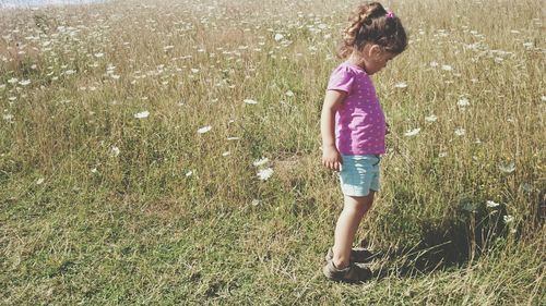 Full length of woman standing on grassy field