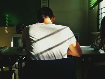 Rear view of man working