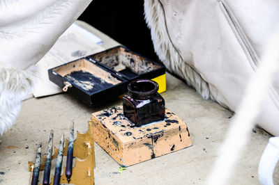 Close-up of messy ink well on table