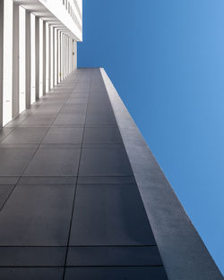 Low angle view of modern building against blue sky