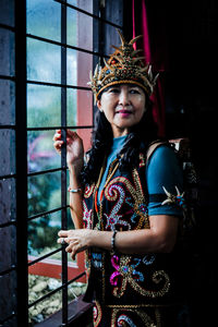 Portrait of young woman standing in city