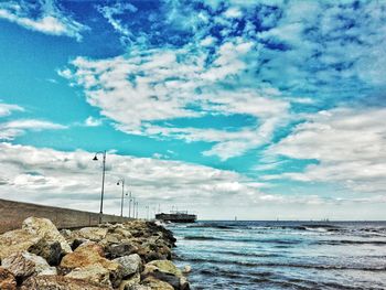 Scenic view of sea against cloudy sky