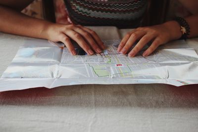 Midsection of girl looking at map