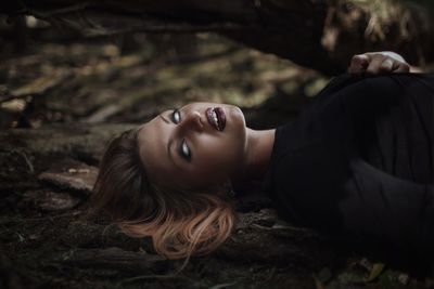 Woman with blind eyes in forest