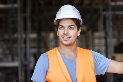 Young construction engineer with helmet working outside