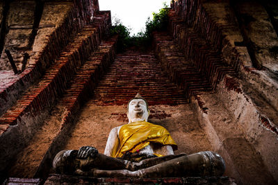 Low angle view of statue against temple building