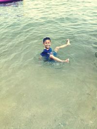 High angle view of young woman swimming in sea