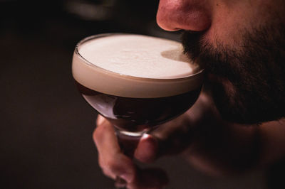 Close-up of man drinking wine