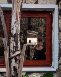 Portrait of woman seen through window of building