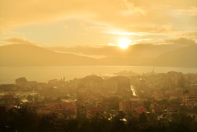 High angle shot of townscape against sky during sunset