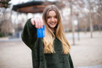 Portrait of smiling young woman standing outdoors