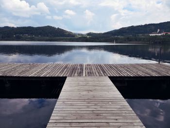 Pier over lake against sky