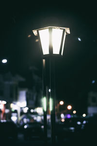 Close-up of illuminated street light at night
