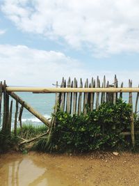 Wooden pier over sea against sky