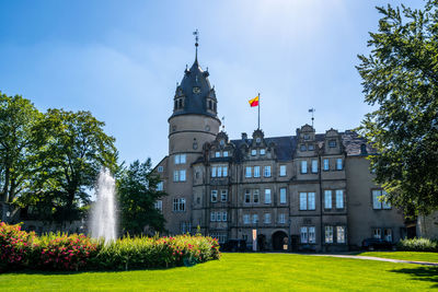 Buildings against the sky with lawn in foreground