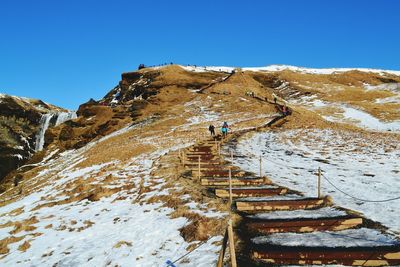 Scenic view of mountains against clear sky during winter