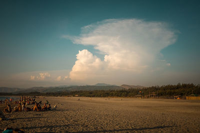 People on beach against sky