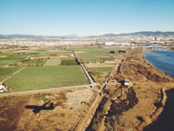Aerial view of agricultural field against clear sky