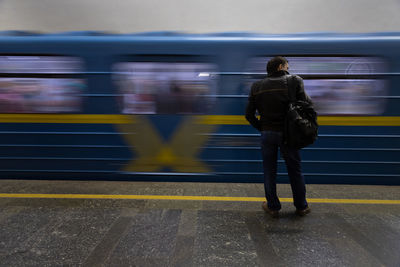 Rear view of man standing at train