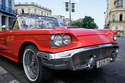 Vintage car on street against buildings in city