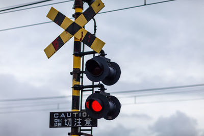 Low angle view of railway signal against sky