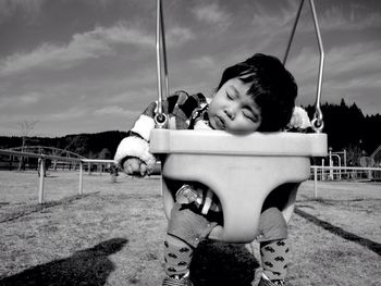 Toddler sleeping in swing