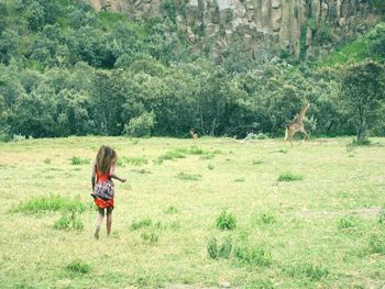 Full length of woman standing on field