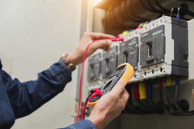 Midsection of man working with mobile phone