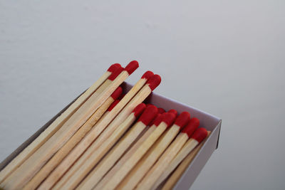 Close-up of matchsticks against gray background