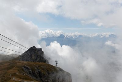 Scenic view of mountains against cloudy sky