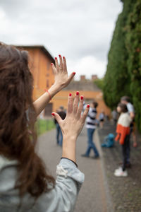 Rear view of woman hands gesturing stop