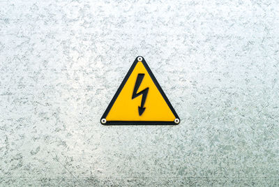 Close-up of yellow sign on black background