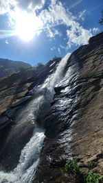 Scenic view of waterfall against sky