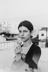 Portrait of young man smoking cigarette