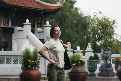 Young woman outdoors near oriental pagoda