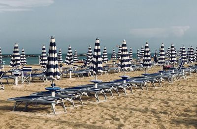 Closed beach umbrellas in a row