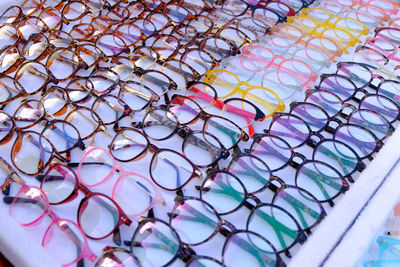 High angle view of multi colored eyeglasses on table at stall