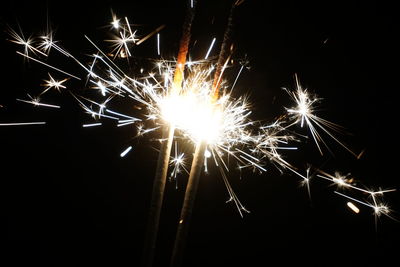 Low angle view of firework display at night