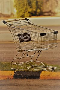 Close-up of shopping cart on road