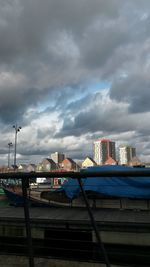 Buildings against cloudy sky