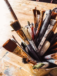 High angle view of paintbrushes in container on table