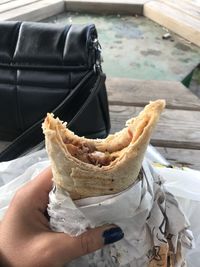 Cropped hand of person holding food