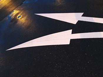 High angle view of arrow sign on road