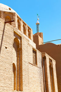 Low angle view of building against clear blue sky